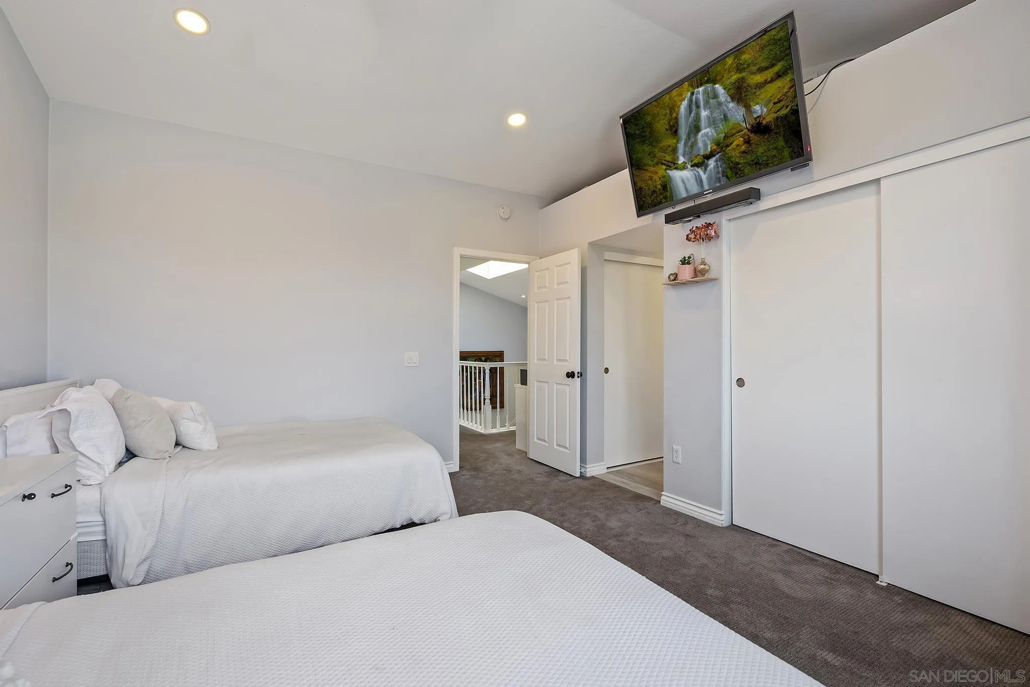 7015 Lavender Way Carlsbad, CA 92011 - Photo 23 of 67 a bedroom with a bed and a flat screen tv