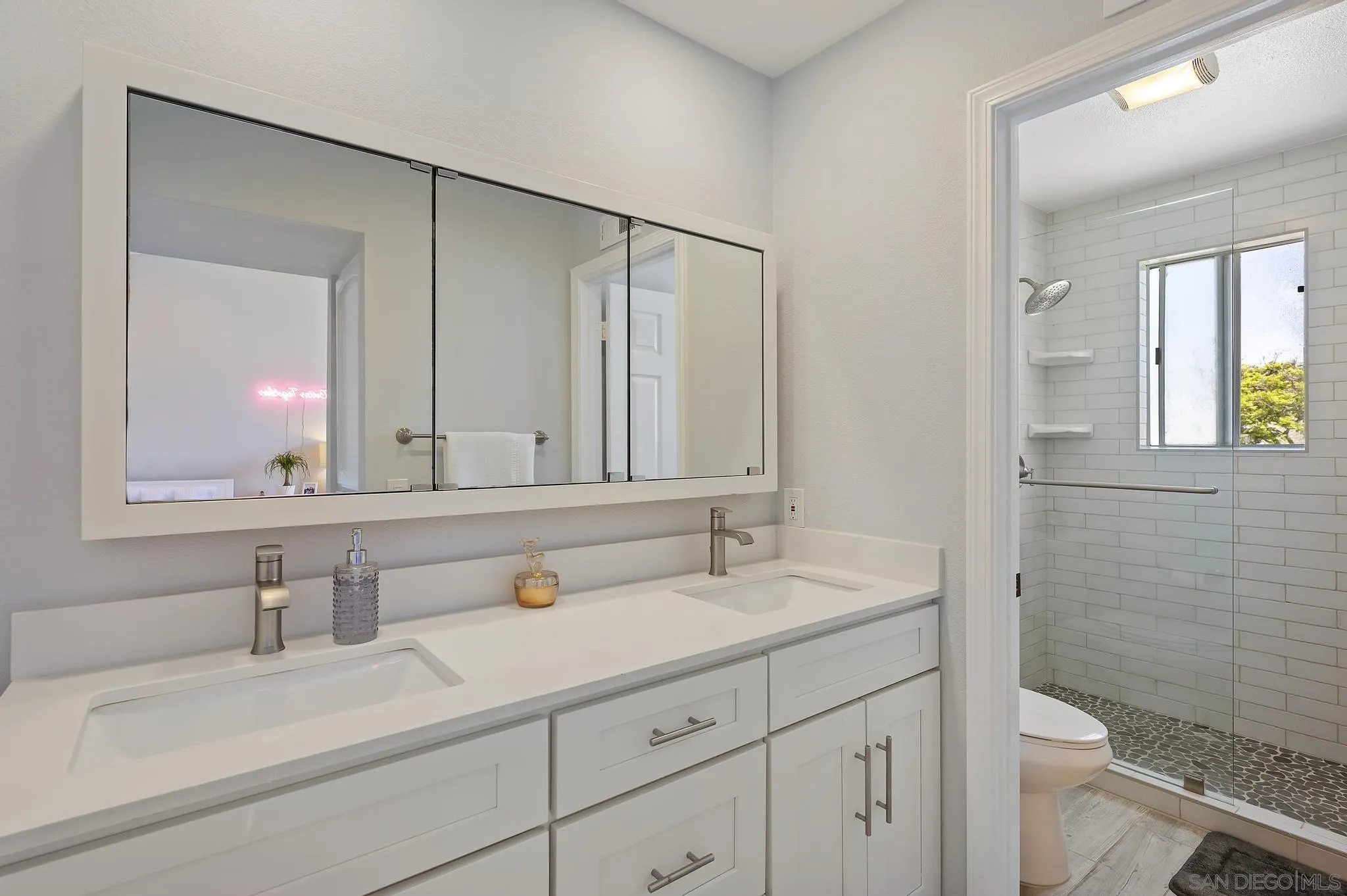 7015 Lavender Way Carlsbad, CA 92011 - Photo 24 of 67 a bathroom with a sink and a mirror