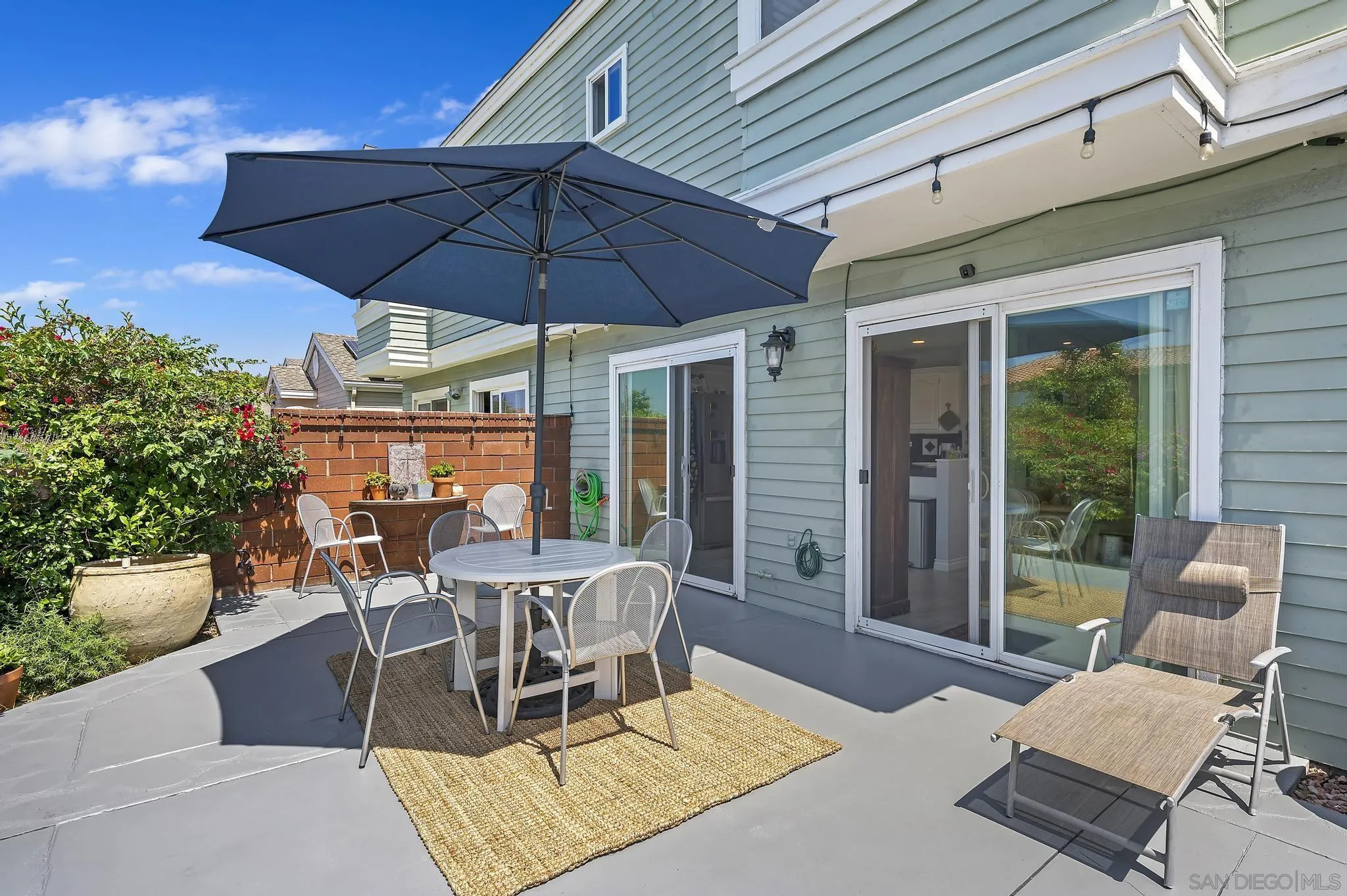 7015 Lavender Way Carlsbad, CA 92011 - Photo 32 of 67 a patio with a patio table and chairs