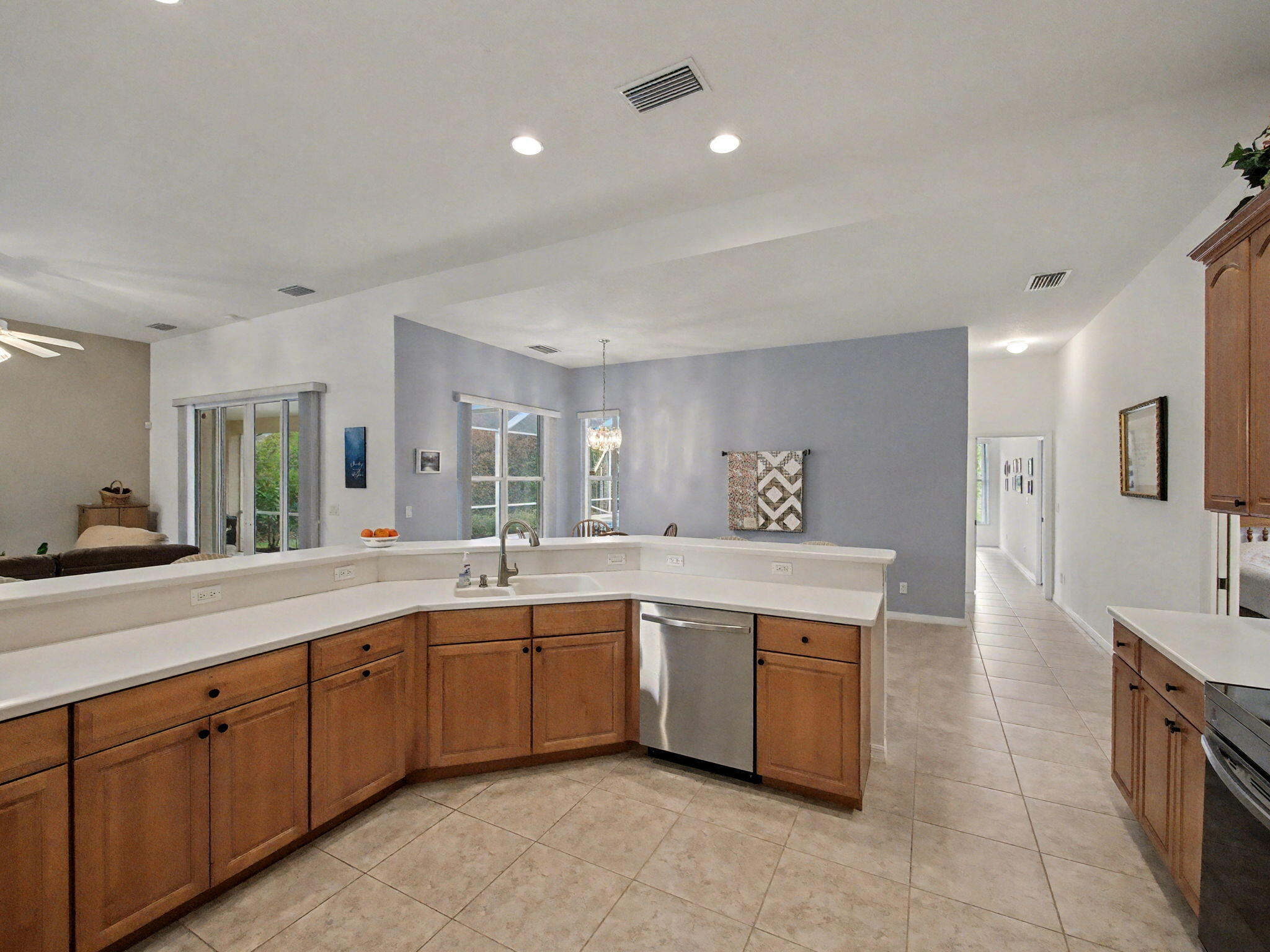 8122 Southwest Yachtsmans Drive Stuart, FL 34997 - Photo 14 of 43 a large kitchen with a sink and dishwasher a stove with wooden floors