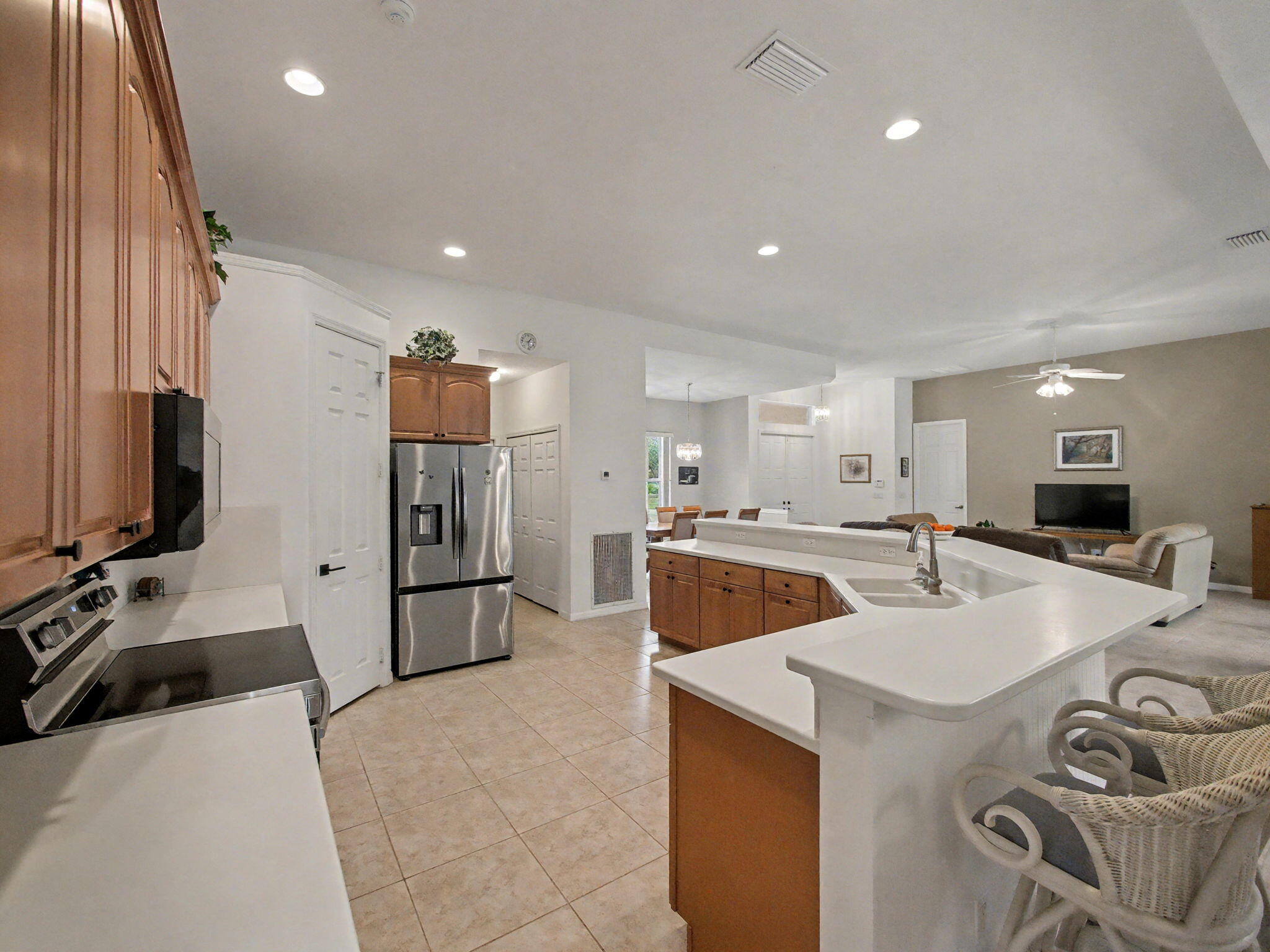 8122 Southwest Yachtsmans Drive Stuart, FL 34997 - Photo 15 of 43 a kitchen with a sink a stove and a refrigerator