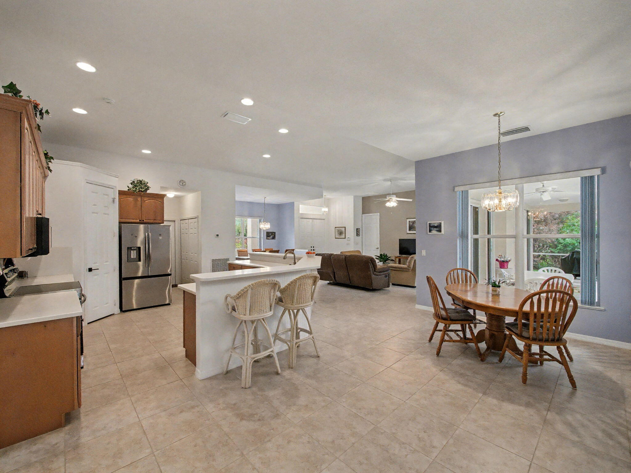 8122 Southwest Yachtsmans Drive Stuart, FL 34997 - Photo 16 of 43 a living room with furniture a flat screen tv and a large window