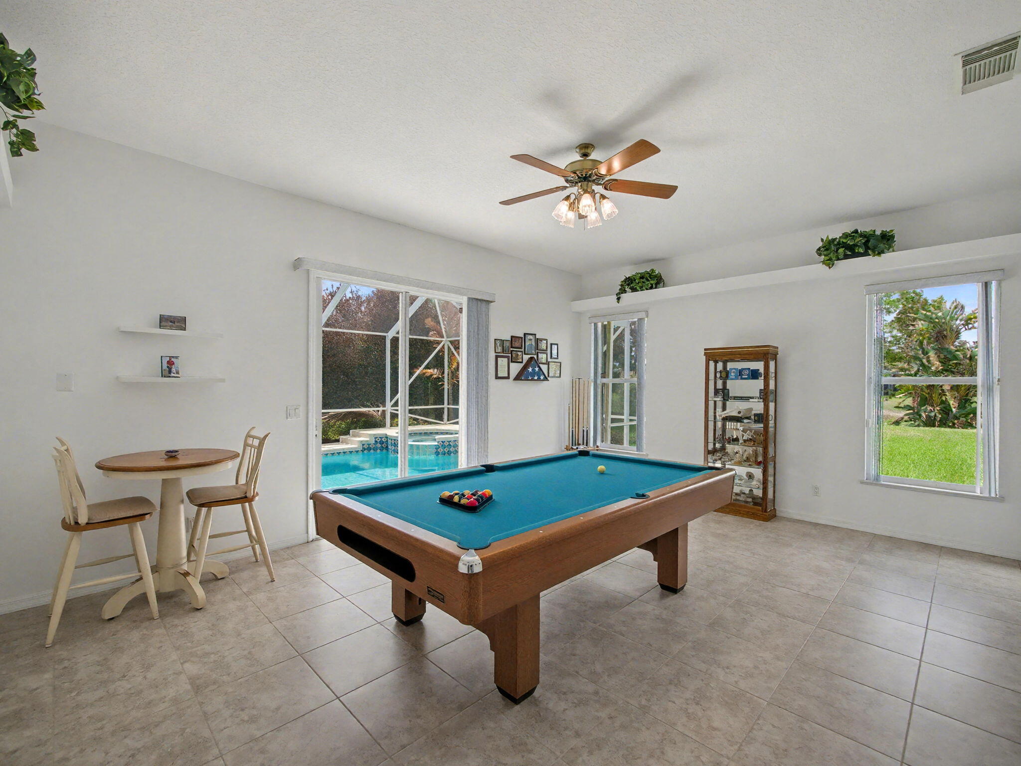 8122 Southwest Yachtsmans Drive Stuart, FL 34997 - Photo 17 of 43 a room with pool table and windows