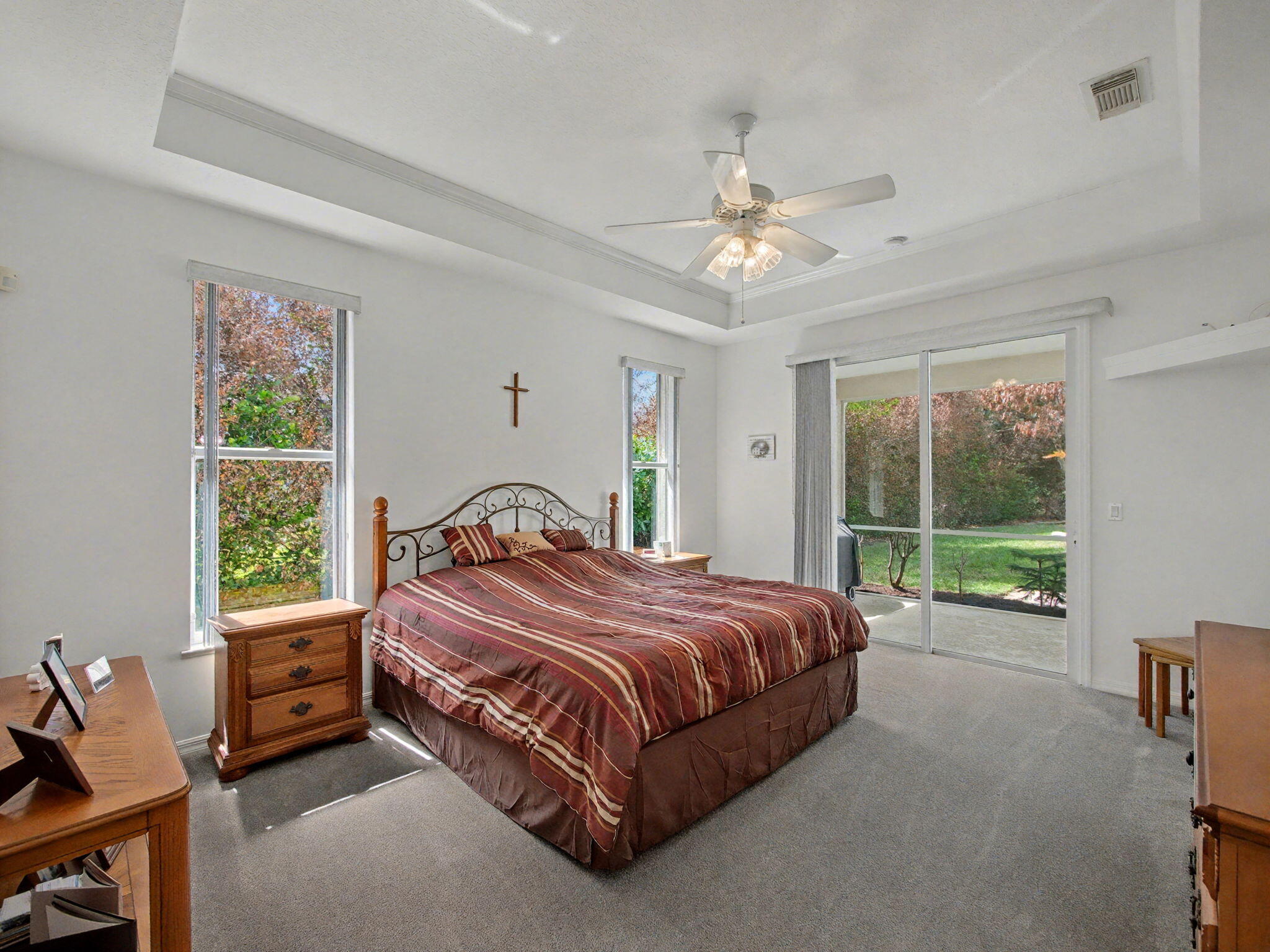 8122 Southwest Yachtsmans Drive Stuart, FL 34997 - Photo 19 of 43 a bedroom with a bed and a chandelier