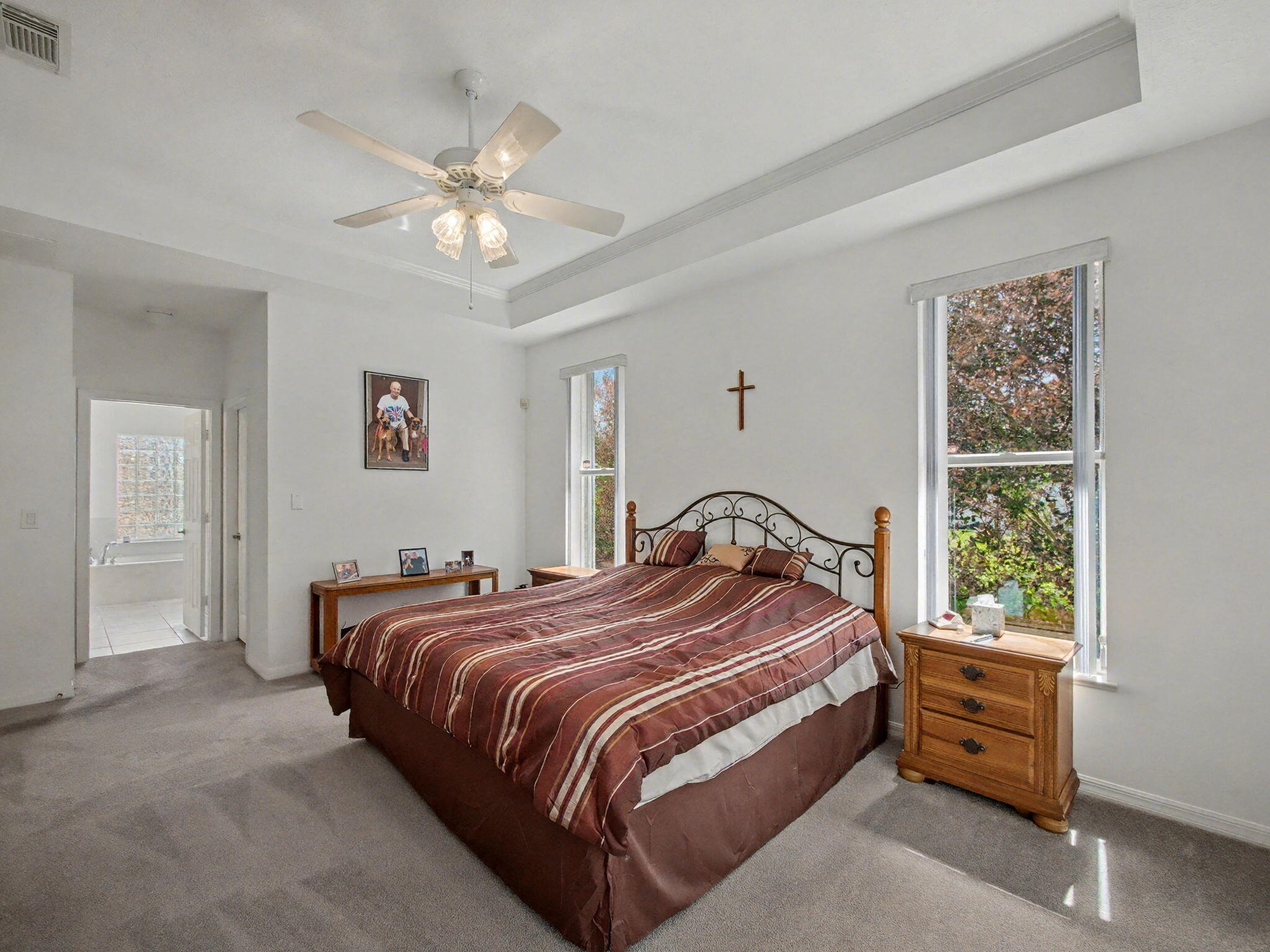 8122 Southwest Yachtsmans Drive Stuart, FL 34997 - Photo 20 of 43 a bedroom with a bed and a chandelier