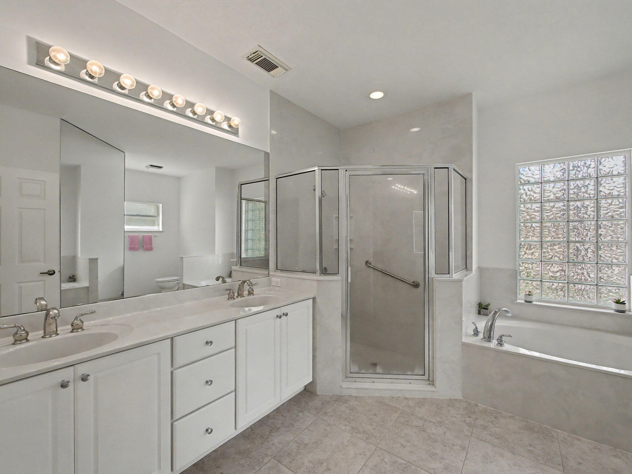 8122 Southwest Yachtsmans Drive Stuart, FL 34997 - Photo 21 of 43 a bathroom with a double vanity sink mirror and double