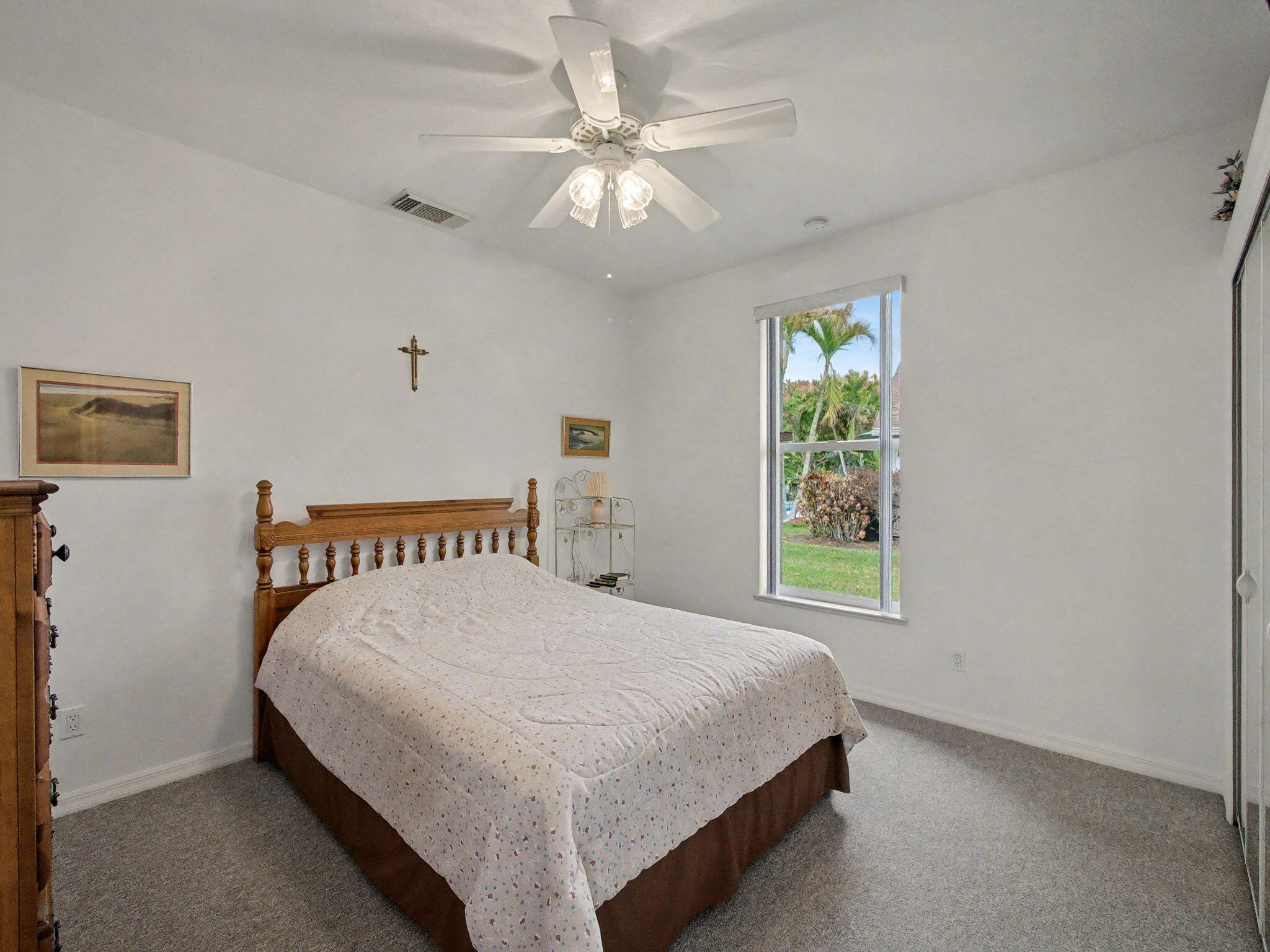 8122 Southwest Yachtsmans Drive Stuart, FL 34997 - Photo 25 of 43 a bedroom with a large bed and a chandelier