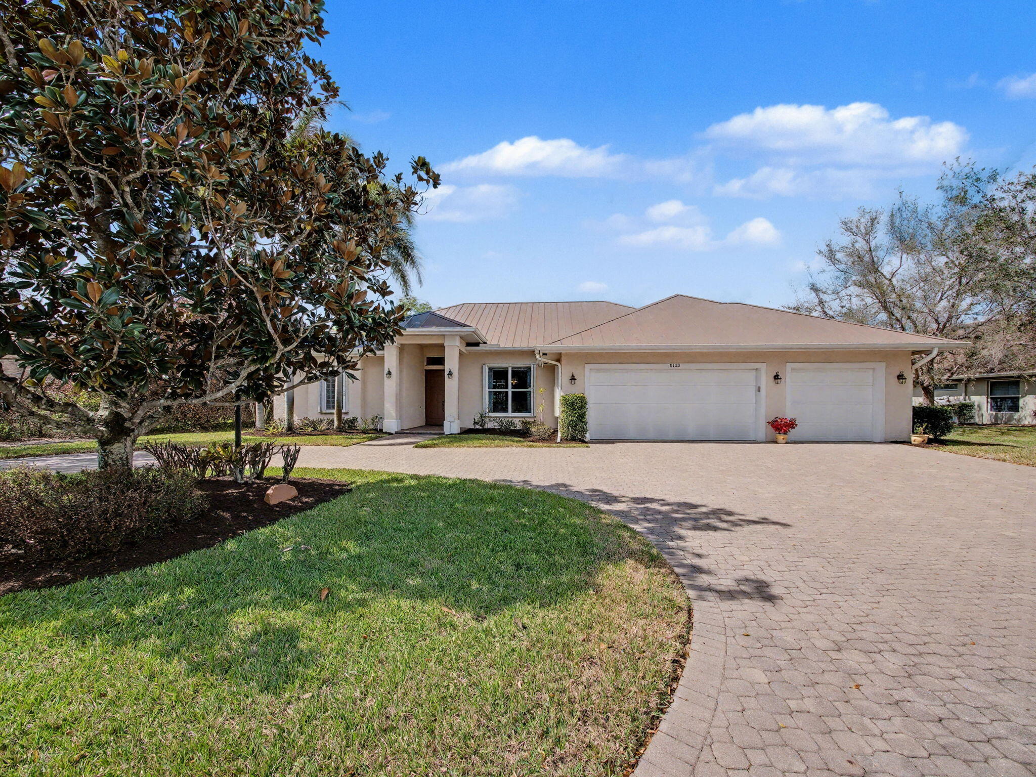8122 Southwest Yachtsmans Drive Stuart, FL 34997 - Photo 3 of 43 front view of a house with a yard
