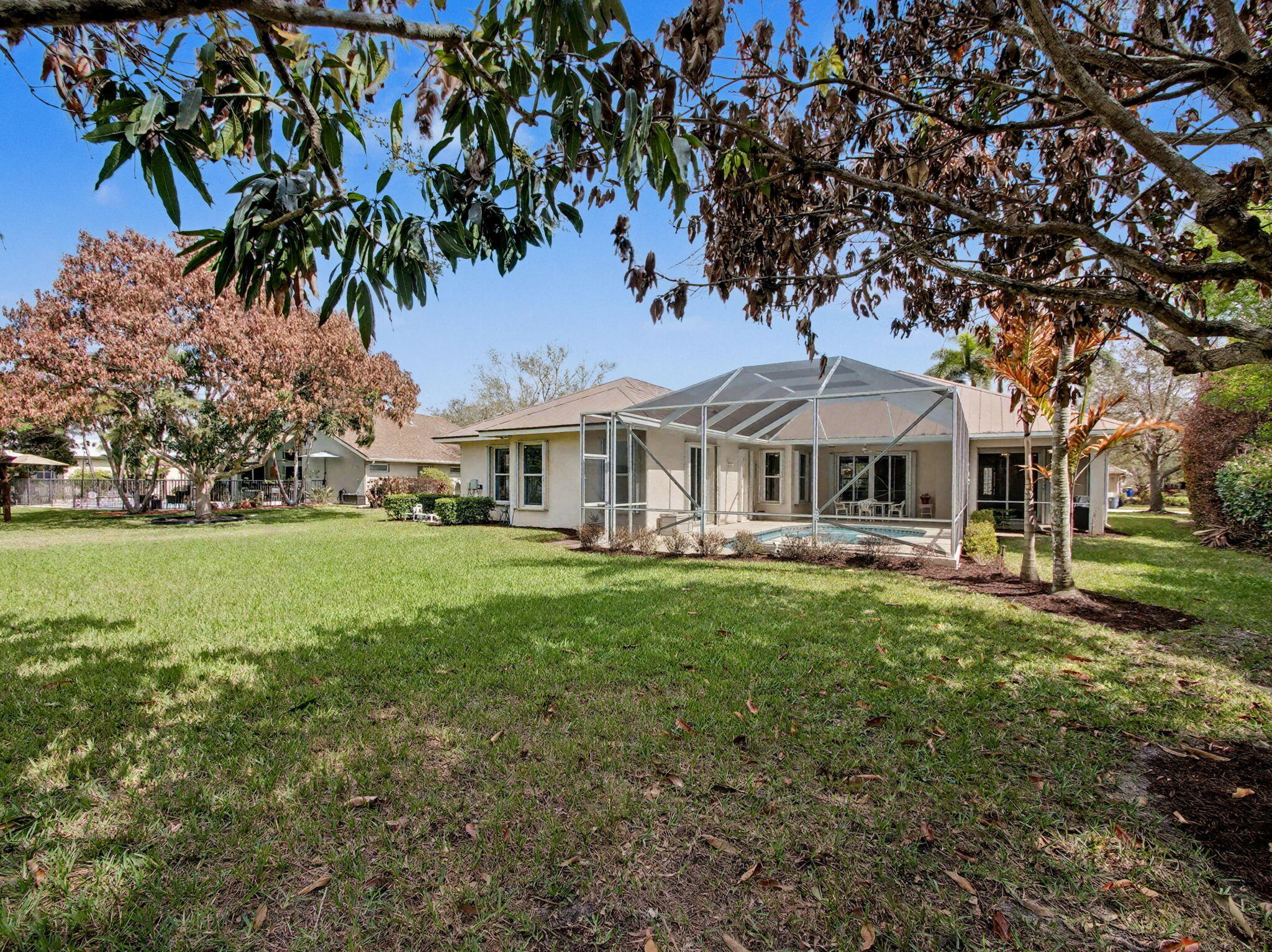 8122 Southwest Yachtsmans Drive Stuart, FL 34997 - Photo 39 of 43 a front view of a house with yard and green space