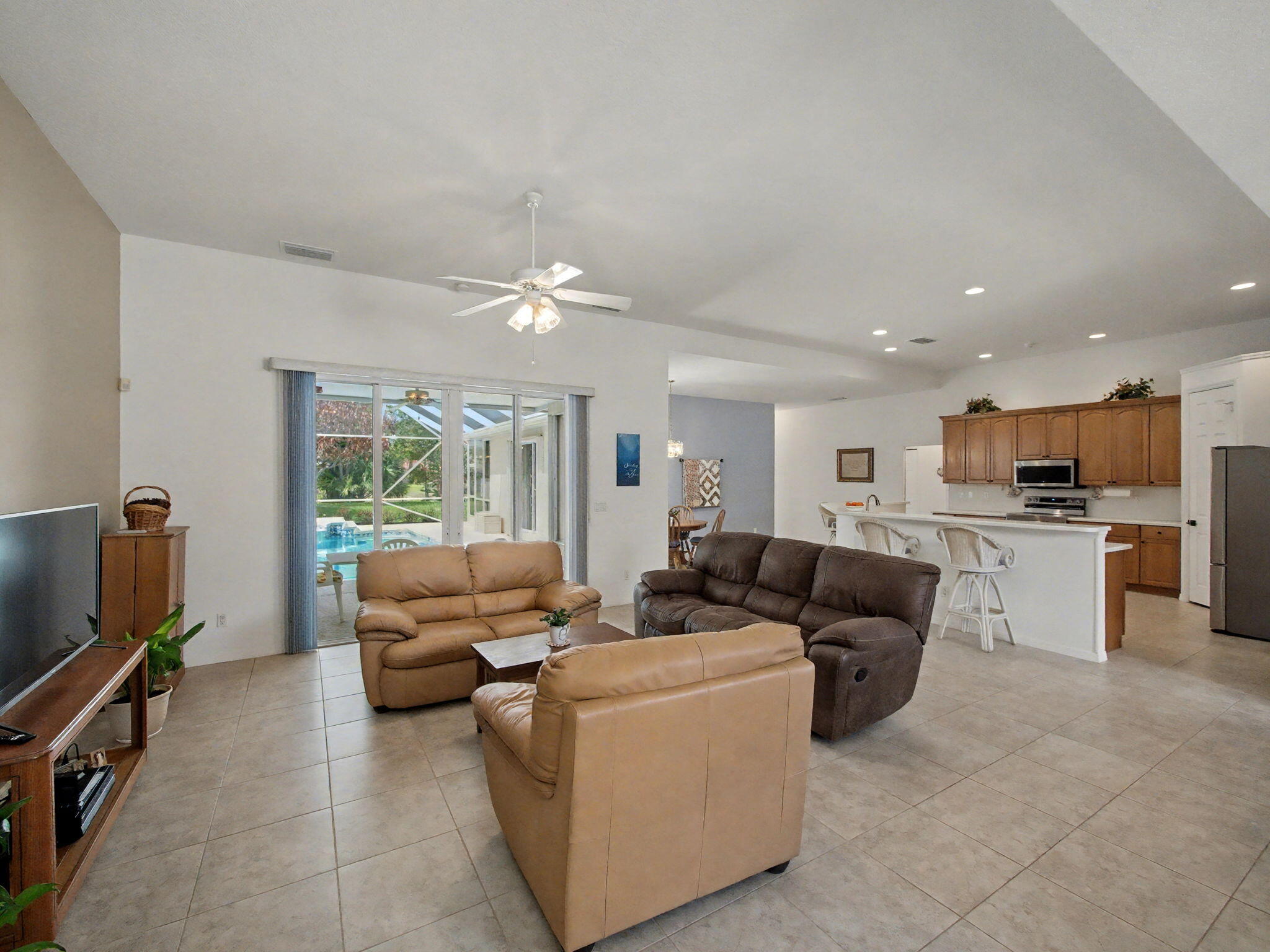 8122 Southwest Yachtsmans Drive Stuart, FL 34997 - Photo 8 of 43 a living room with furniture and a flat screen tv