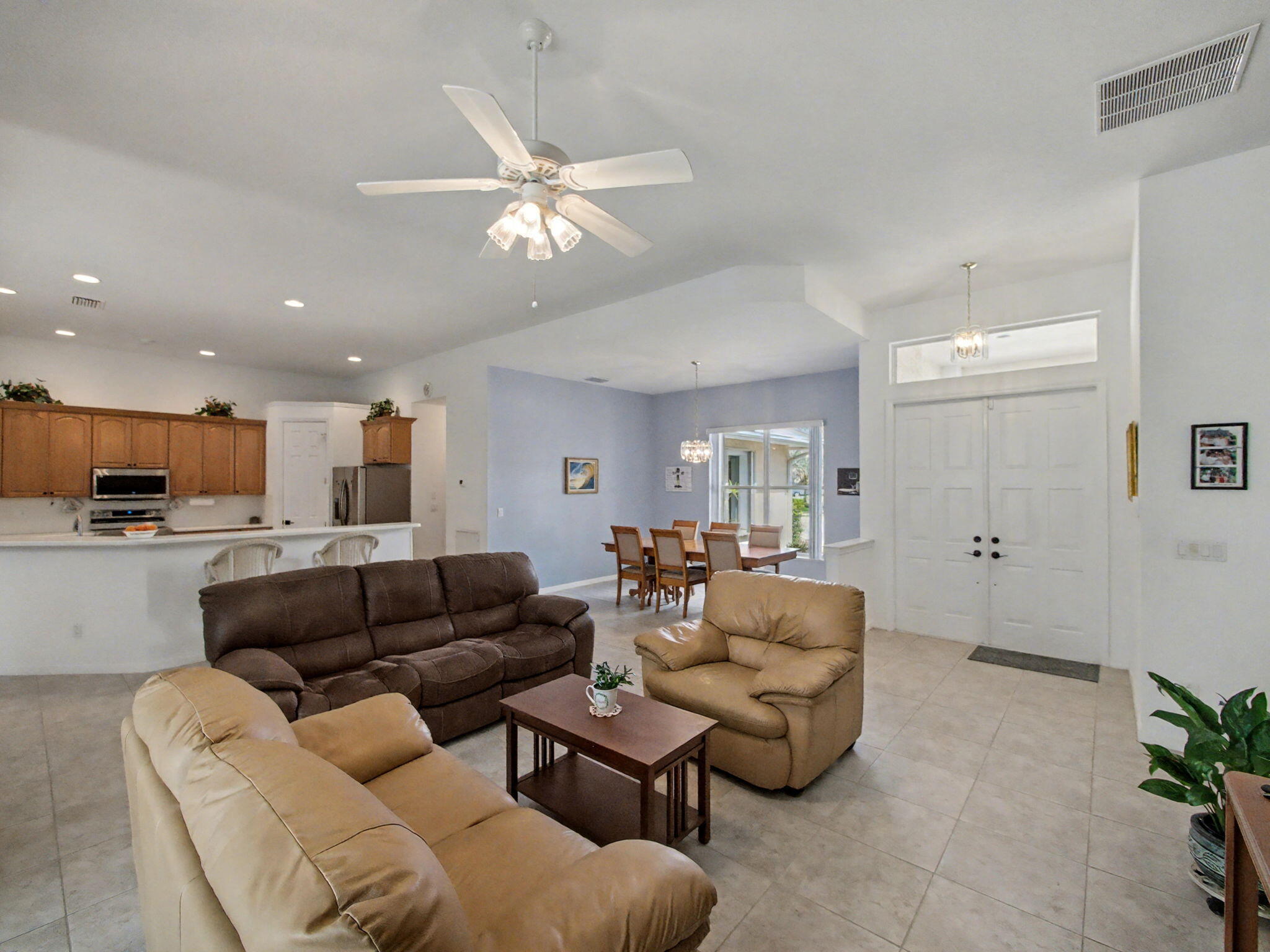 8122 Southwest Yachtsmans Drive Stuart, FL 34997 - Photo 9 of 43 a living room with furniture and a view of kitchen