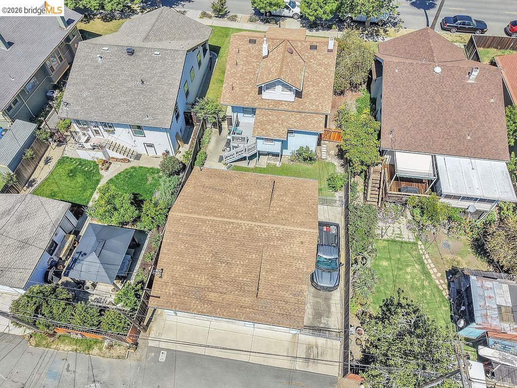325 South 2nd Street Rio Vista, CA 94571 - Photo 28 of 33 Property featuring two distinct buildings with brown shingle roofs, a paved driveway, and a fenced rear yard with mature landscaping and a stone pathway