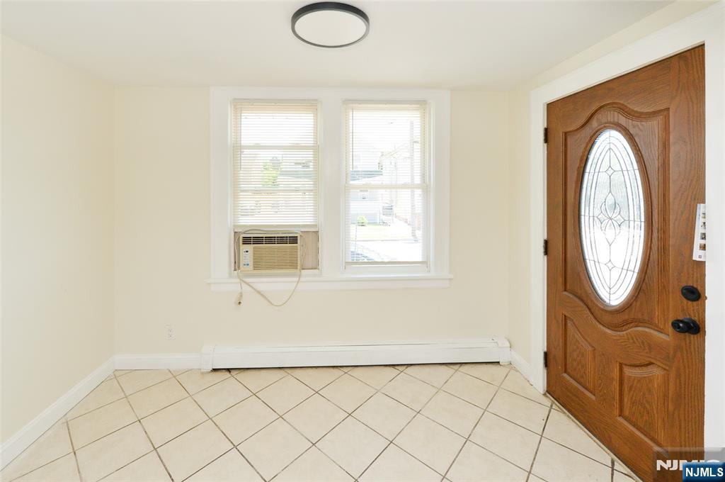 62 Broadway, Unit 1 Hackensack, NJ 07601 - Photo 4 of 25 a view of a livingroom with washer and dryer