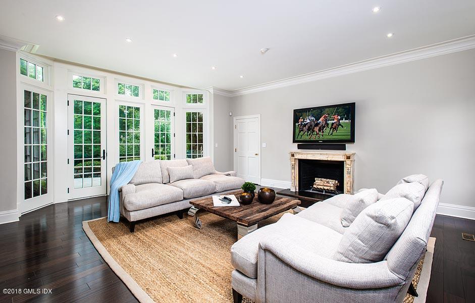 2 Round Hill Road Greenwich, CT 06831 - Photo 14 of 34 a living room with furniture fireplace and a flat screen tv