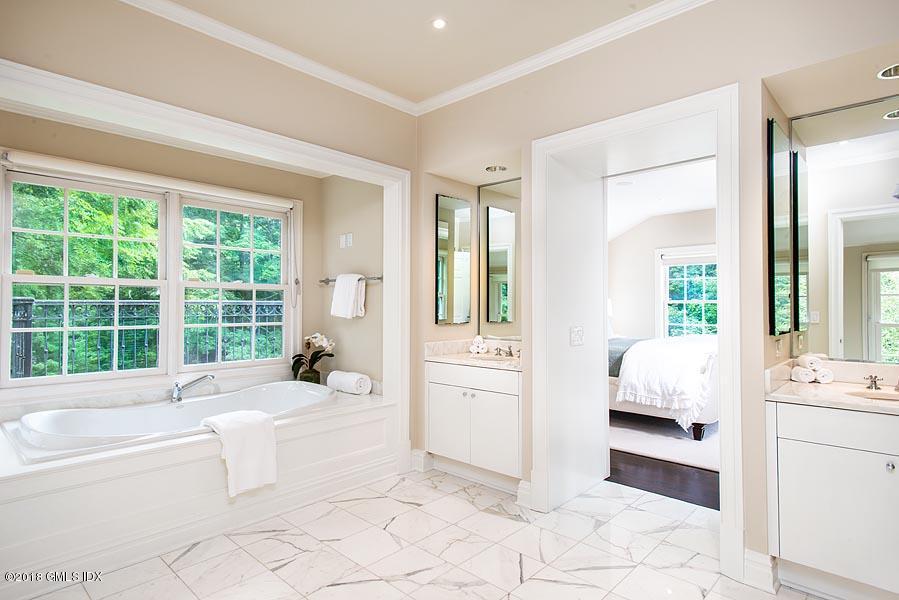 2 Round Hill Road Greenwich, CT 06831 - Photo 20 of 34 a spacious en suite bathroom with a tub sink and view bedroom