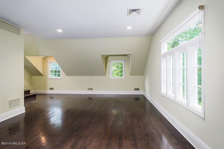 2 Round Hill Road Greenwich, CT 06831 - Photo 23 of 34 an empty room with wooden floor and windows