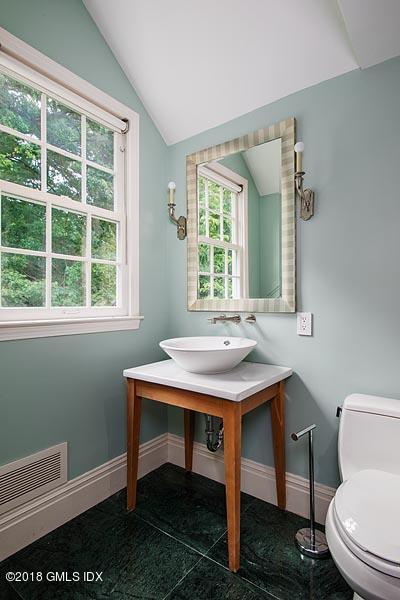 2 Round Hill Road Greenwich, CT 06831 - Photo 24 of 34 a bathroom with a sink a toilet and a window