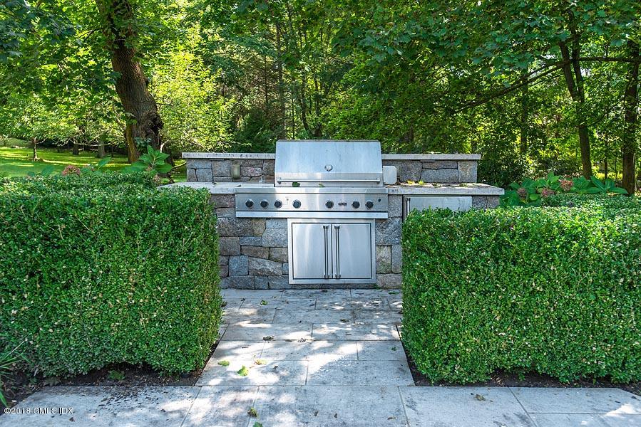 2 Round Hill Road Greenwich, CT 06831 - Photo 33 of 34 a view of a backyard with plants and a garden