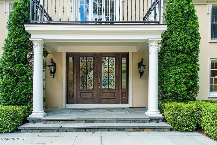2 Round Hill Road Greenwich, CT 06831 - Photo 34 of 34 a front view of a house with a floor to ceiling windows and plants