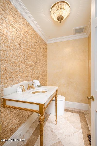 2 Round Hill Road Greenwich, CT 06831 - Photo 9 of 34 a bathroom with a sink and a mirror