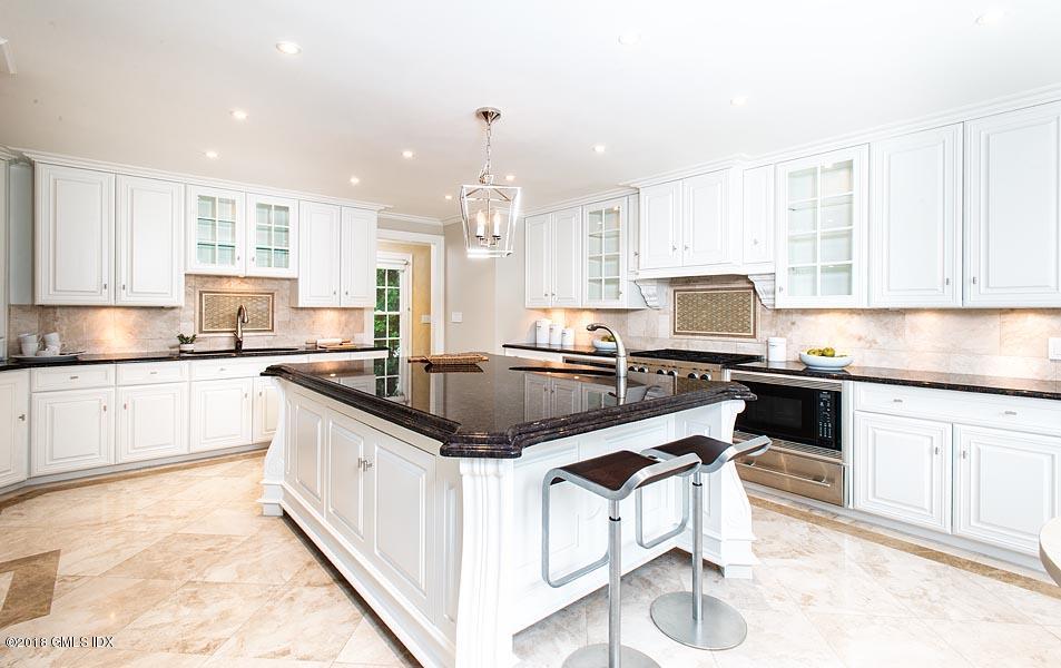 2 Round Hill Road Greenwich, CT 06831 - Photo 10 of 34 a kitchen with stainless steel appliances granite countertop a sink stove and cabinets