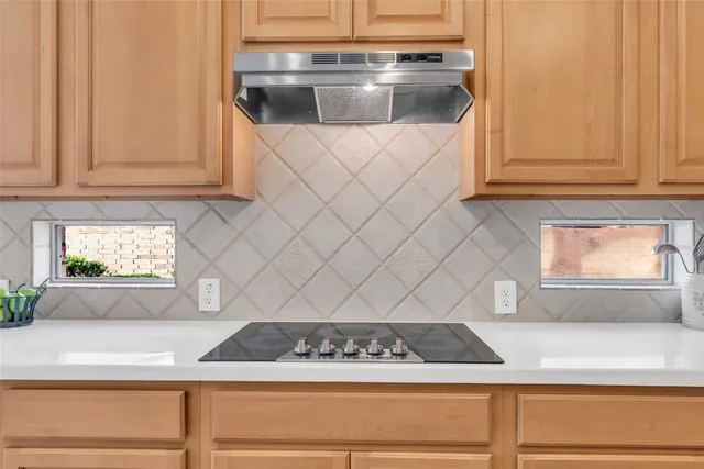 a kitchen with stainless steel appliances kitchen island wooden cabinets and wooden floor