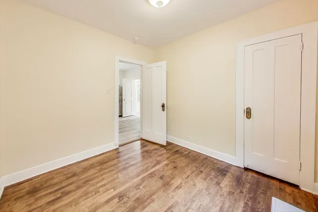 a view of an empty room and wooden floor