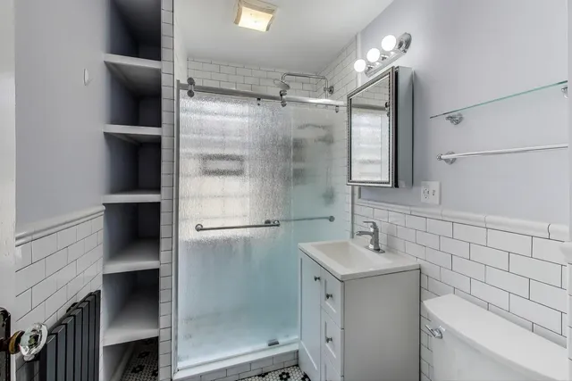 a view of a big room with windows and chandelier