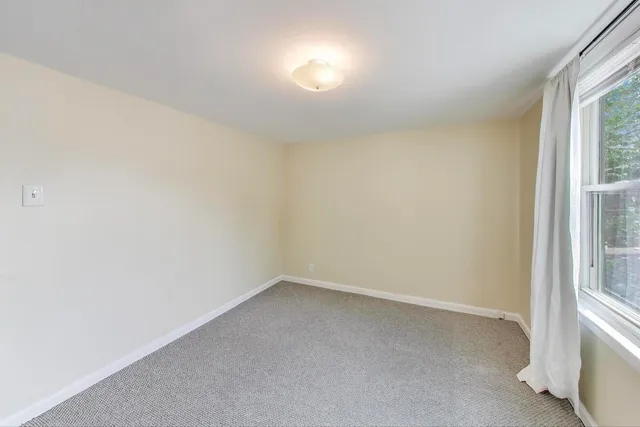 a view of a field with trees in the background