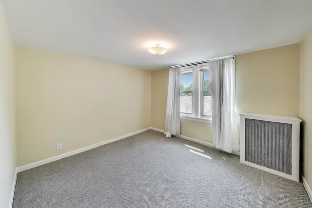 a view of a field with trees in the background