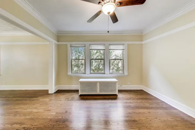 a kitchen with stainless steel appliances granite countertop a stove top oven a sink dishwasher and a refrigerator with wooden floor