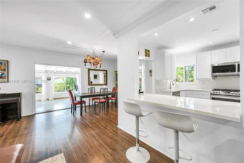 a large kitchen with a table and chairs