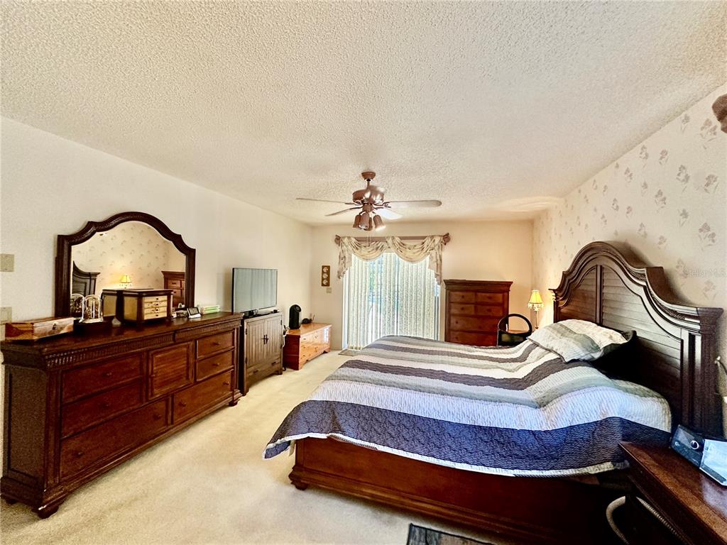 262 Santa Rosa Drive Winter Haven, FL 33884 - Photo 19 of 40 a bedroom with a bed and a dresser with mirror