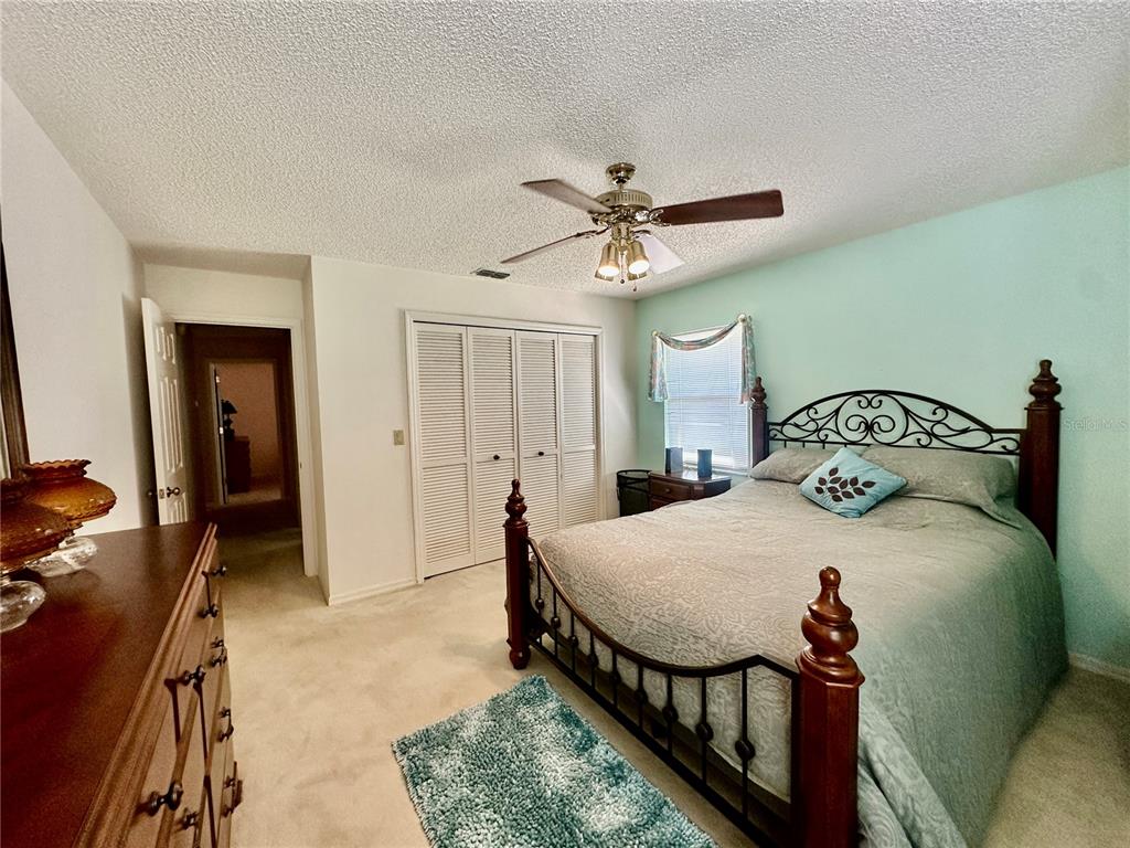 262 Santa Rosa Drive Winter Haven, FL 33884 - Photo 25 of 40 a bedroom with a bed and a chandelier