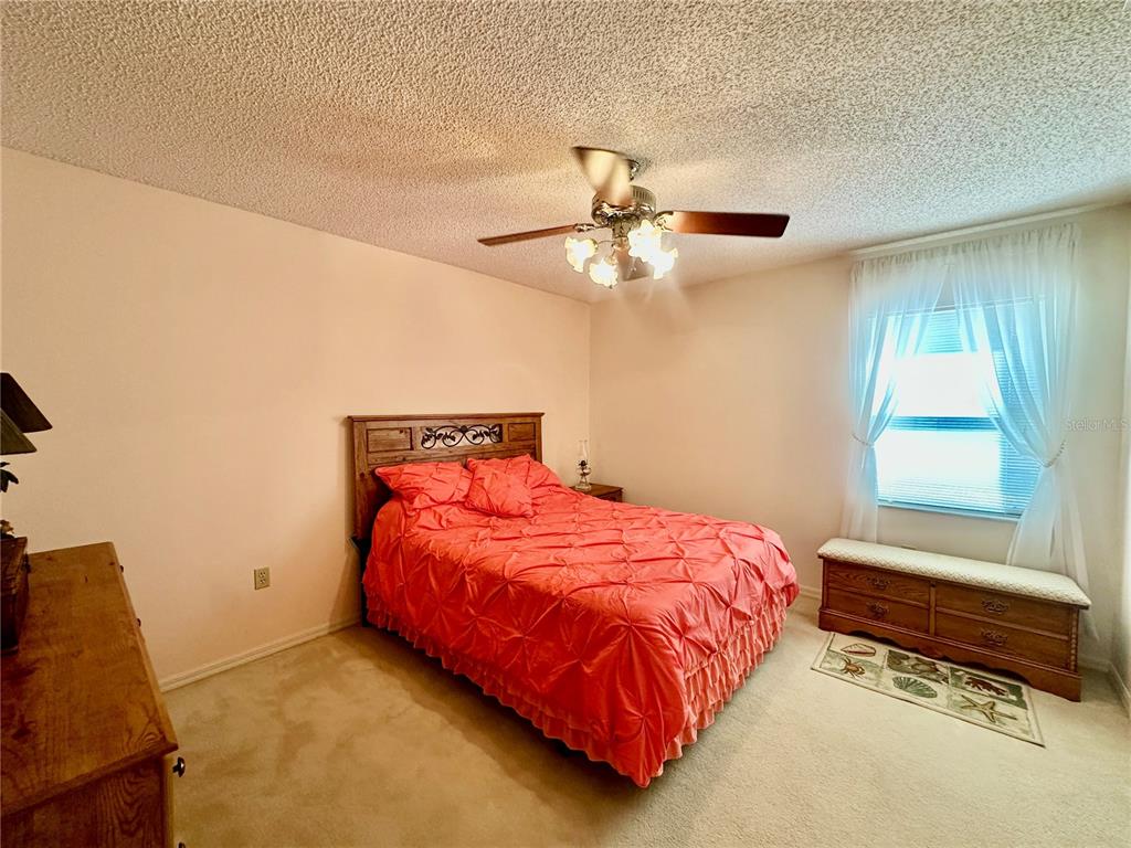 262 Santa Rosa Drive Winter Haven, FL 33884 - Photo 26 of 40 a bedroom with a bed and a chandelier