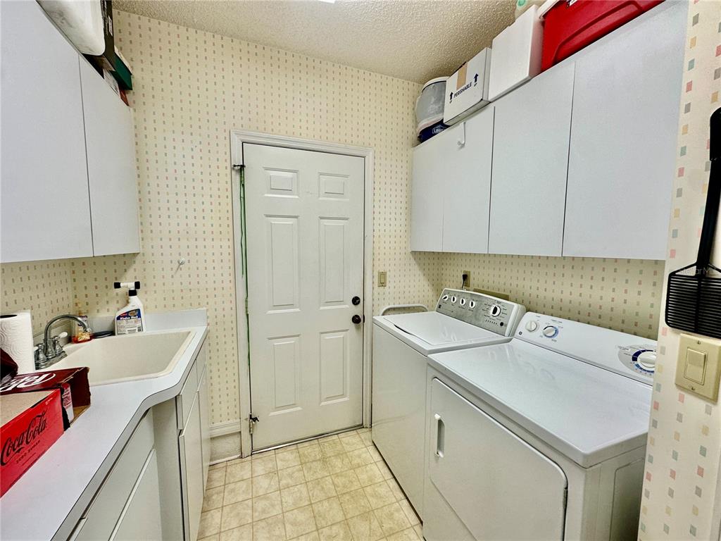 262 Santa Rosa Drive Winter Haven, FL 33884 - Photo 31 of 40 a utility room with cabinets washer and dryer