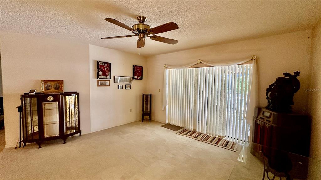 262 Santa Rosa Drive Winter Haven, FL 33884 - Photo 4 of 40 a view of a livingroom with a ceiling fan and window