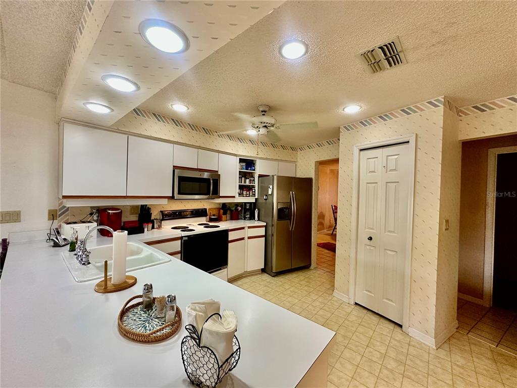 262 Santa Rosa Drive Winter Haven, FL 33884 - Photo 9 of 40 a kitchen with stainless steel appliances granite countertop a refrigerator and a sink