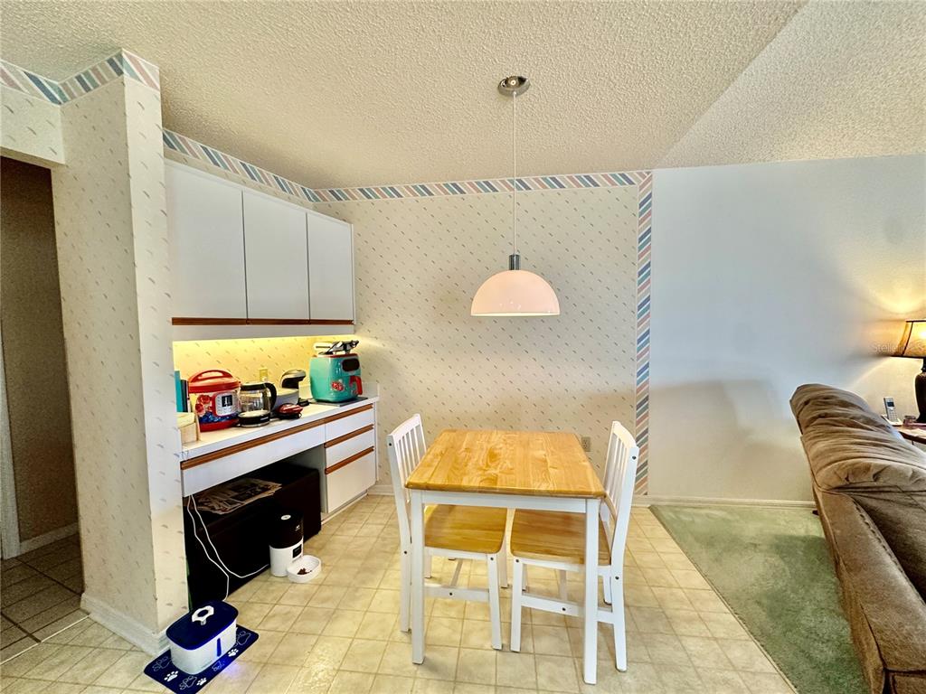 262 Santa Rosa Drive Winter Haven, FL 33884 - Photo 10 of 40 a kitchen with granite countertop a stove a sink and a microwave