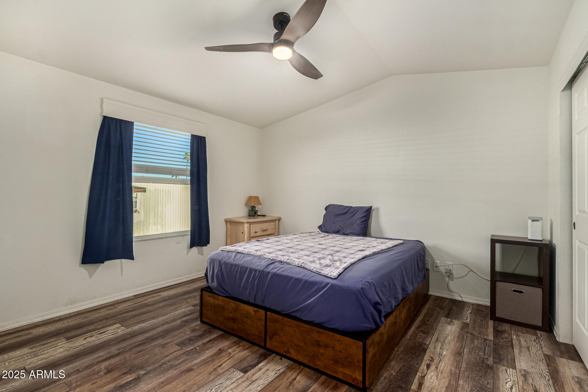 16225 North Cave Creek Road, Unit 85 Phoenix, AZ 85032 - Photo 11 of 36 a bedroom with a bed and wooden floor