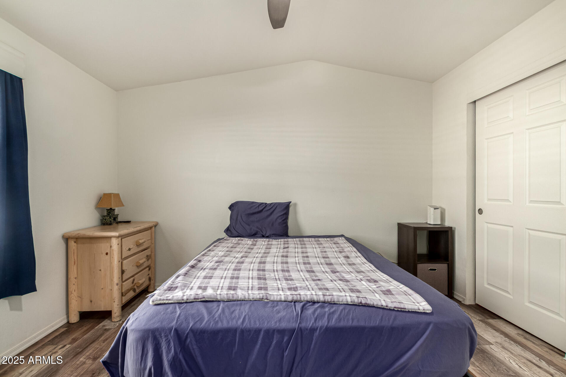 16225 North Cave Creek Road, Unit 85 Phoenix, AZ 85032 - Photo 13 of 36 a bedroom with a bed and wooden floor