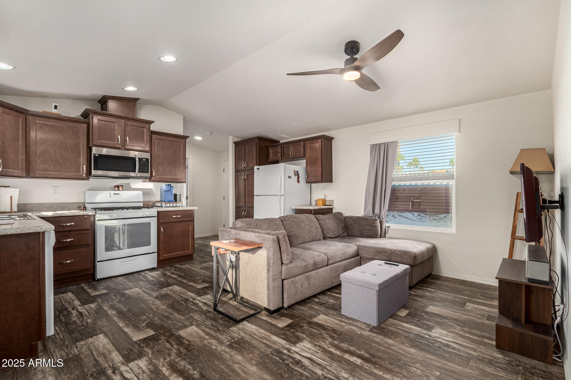 16225 North Cave Creek Road, Unit 85 Phoenix, AZ 85032 - Photo 2 of 36 a living room with furniture a flat screen tv and a fireplace