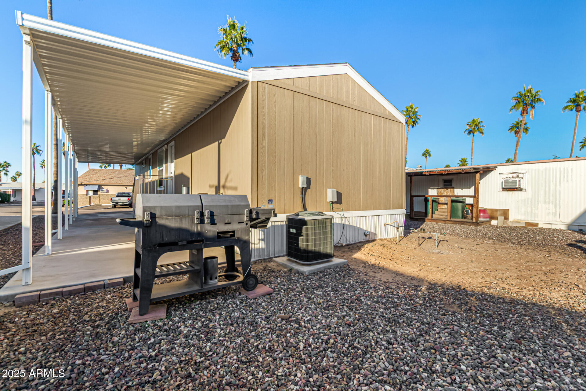 16225 North Cave Creek Road, Unit 85 Phoenix, AZ 85032 - Photo 23 of 36 a view of a patio with a table and chairs under an umbrella