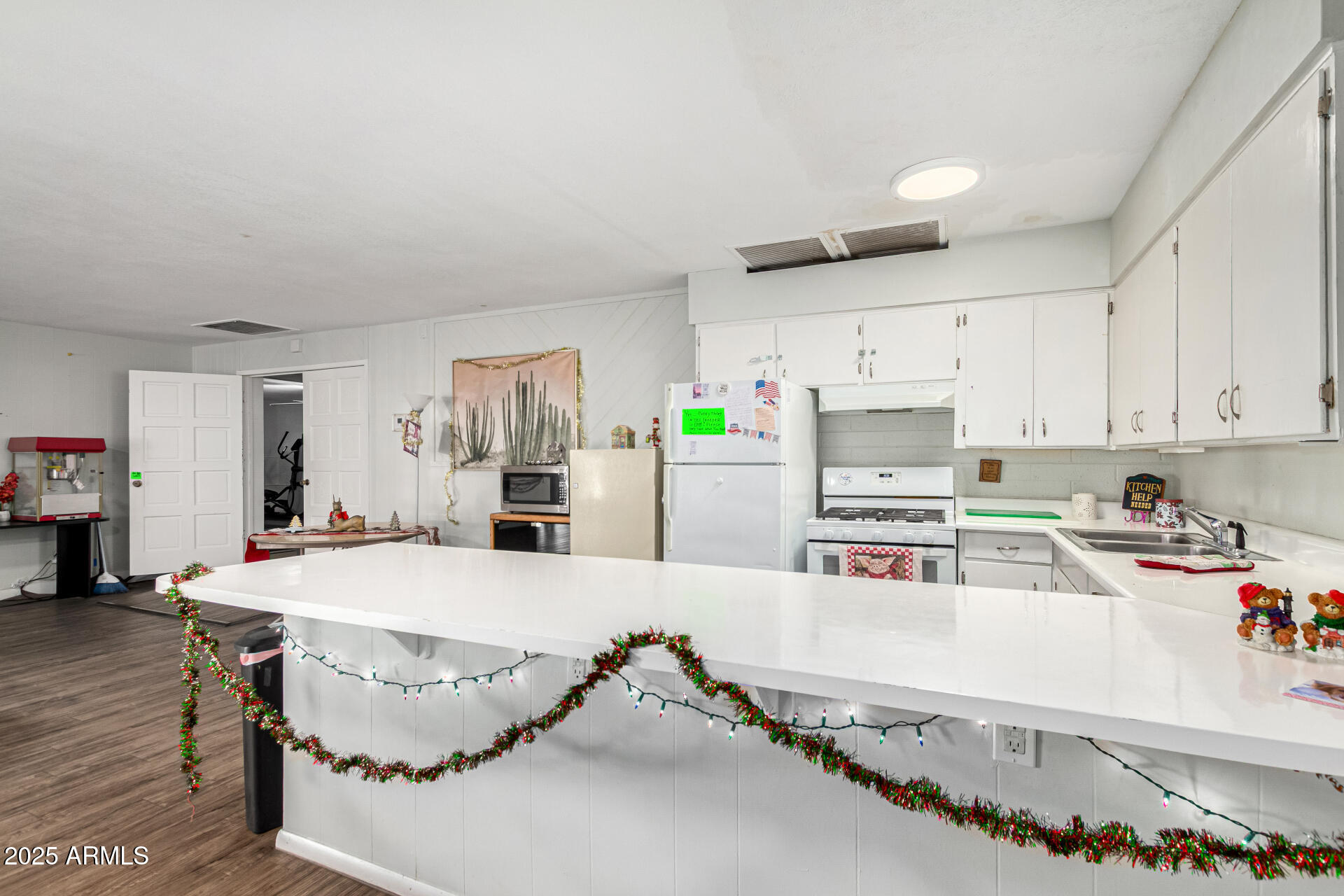 16225 North Cave Creek Road, Unit 85 Phoenix, AZ 85032 - Photo 26 of 36 a kitchen with stainless steel appliances kitchen island granite countertop a sink and cabinets