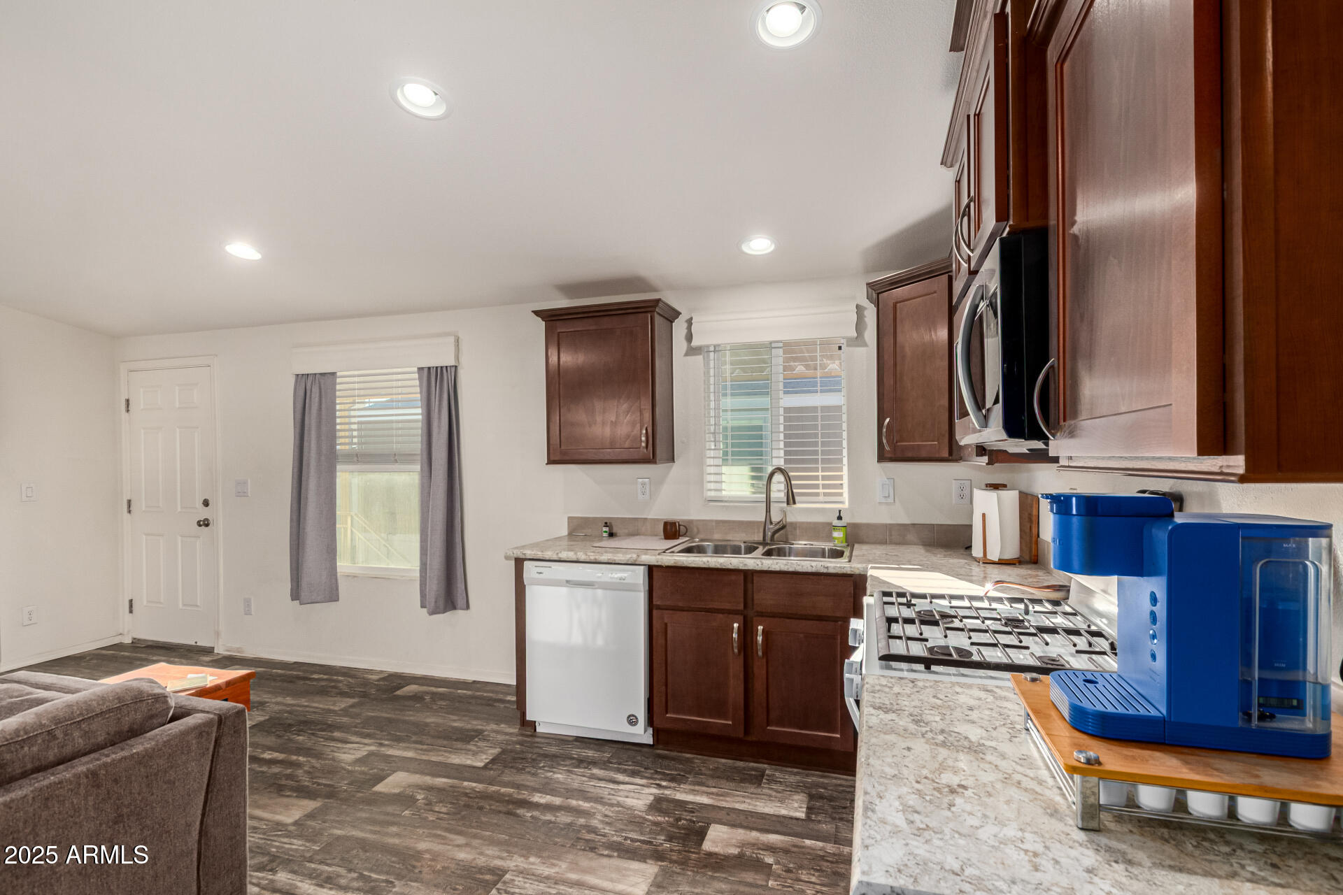 16225 North Cave Creek Road, Unit 85 Phoenix, AZ 85032 - Photo 5 of 36 a kitchen with stainless steel appliances granite countertop a sink stove and cabinets