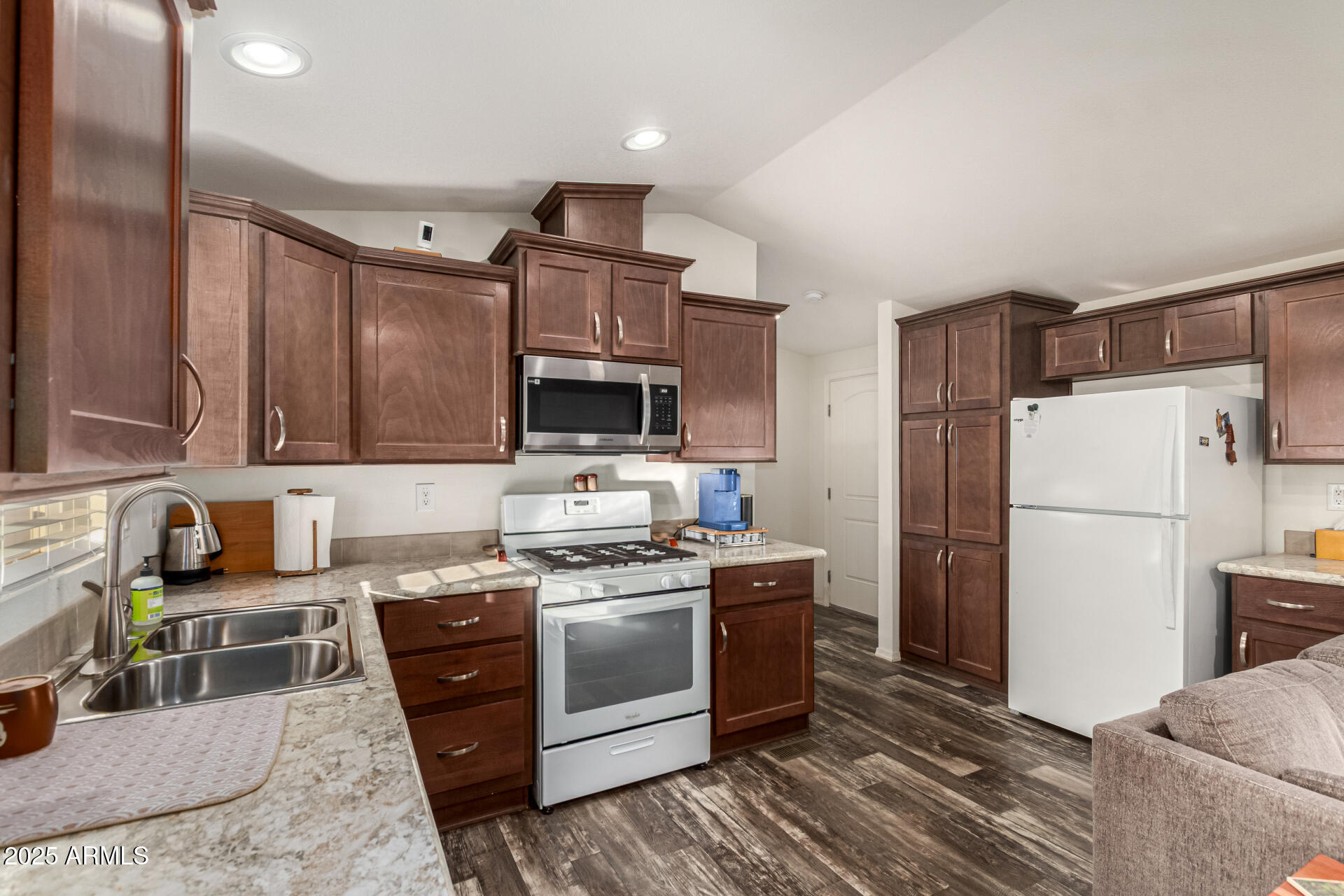 16225 North Cave Creek Road, Unit 85 Phoenix, AZ 85032 - Photo 6 of 36 a kitchen with stainless steel appliances a stove a sink and a refrigerator