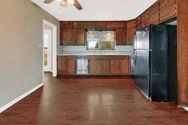 a view of kitchen with stainless steel appliances wooden floor
