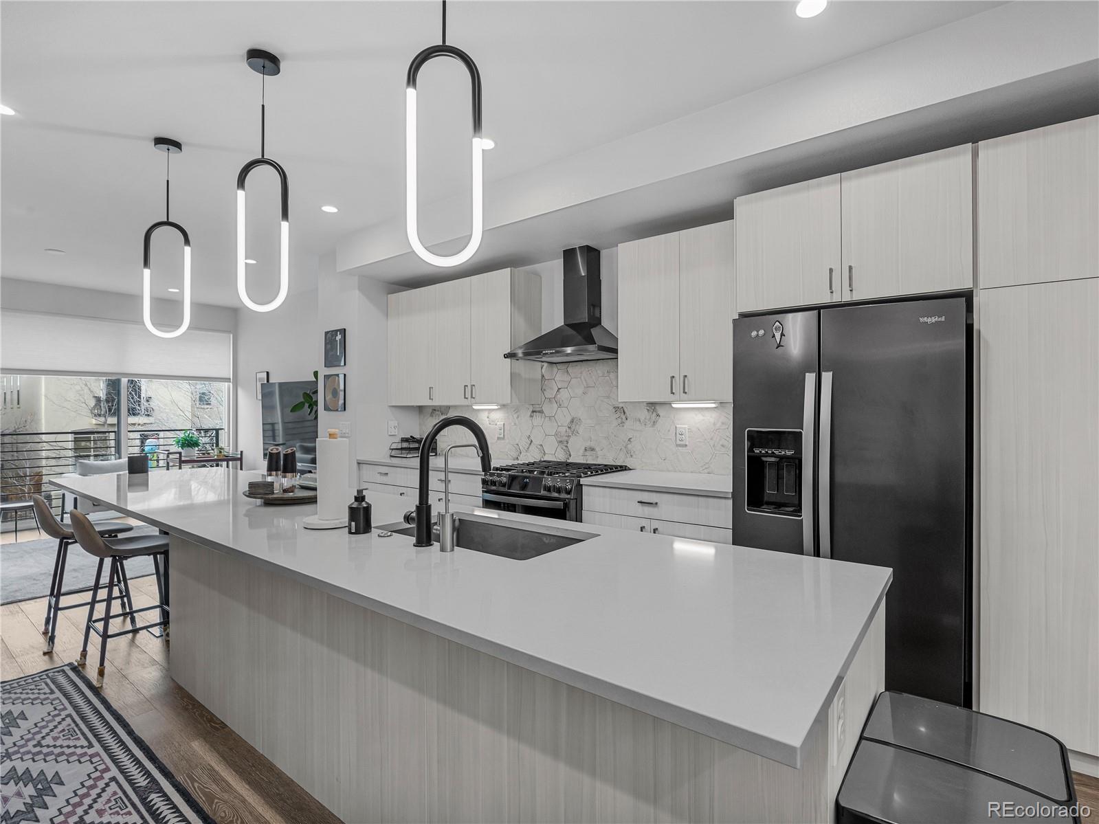 2350 Tremont Place, Unit 6 Denver, CO 80205 - Photo 11 of 40 a kitchen with stainless steel appliances a sink refrigerator and microwave