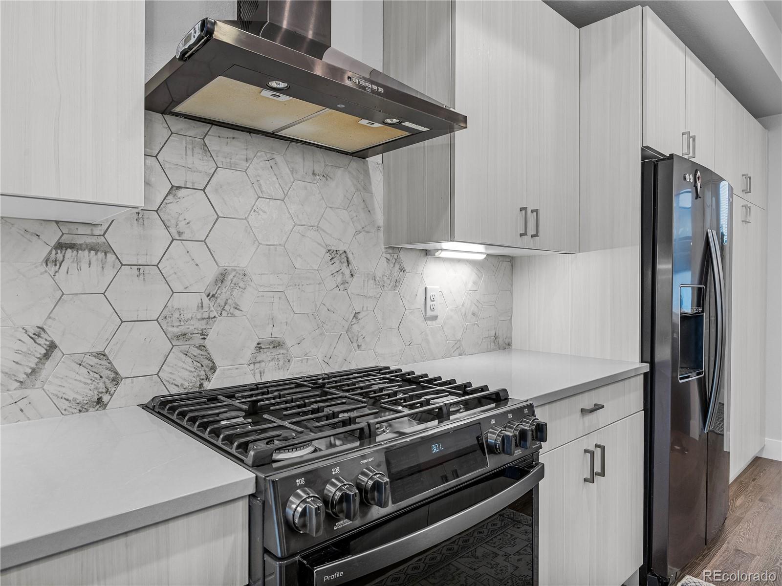 2350 Tremont Place, Unit 6 Denver, CO 80205 - Photo 14 of 40 a stove top oven sitting inside of a kitchen