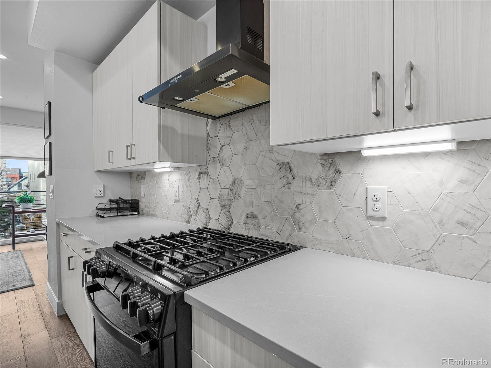 2350 Tremont Place, Unit 6 Denver, CO 80205 - Photo 16 of 40 a kitchen with granite countertop a stove and a sink